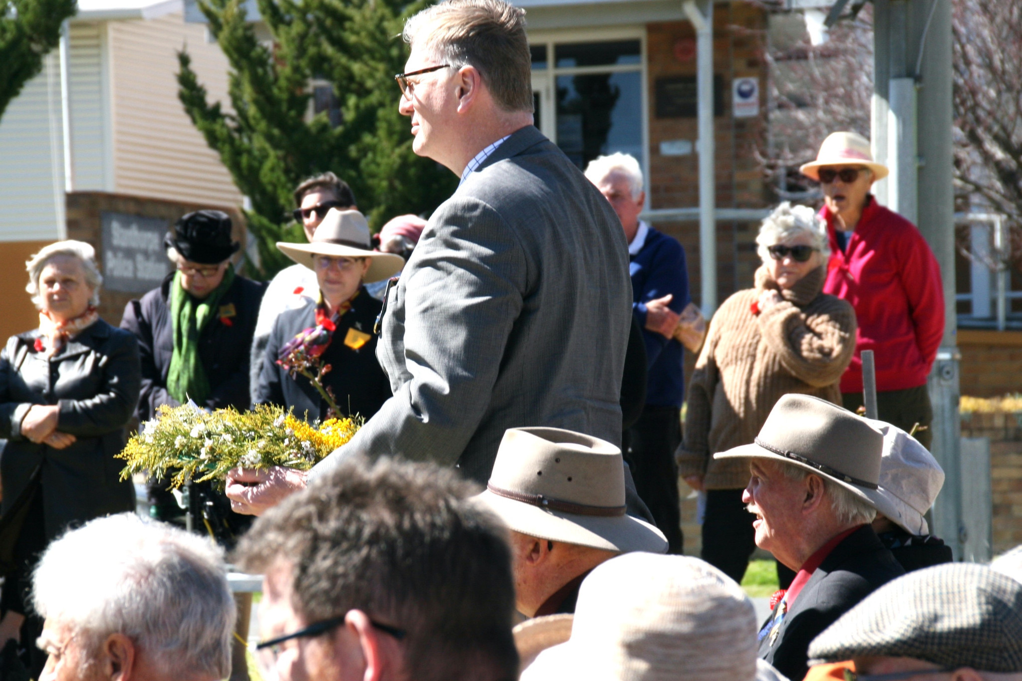 James Lister MP presents his wattle-inspired wreath on August 18.