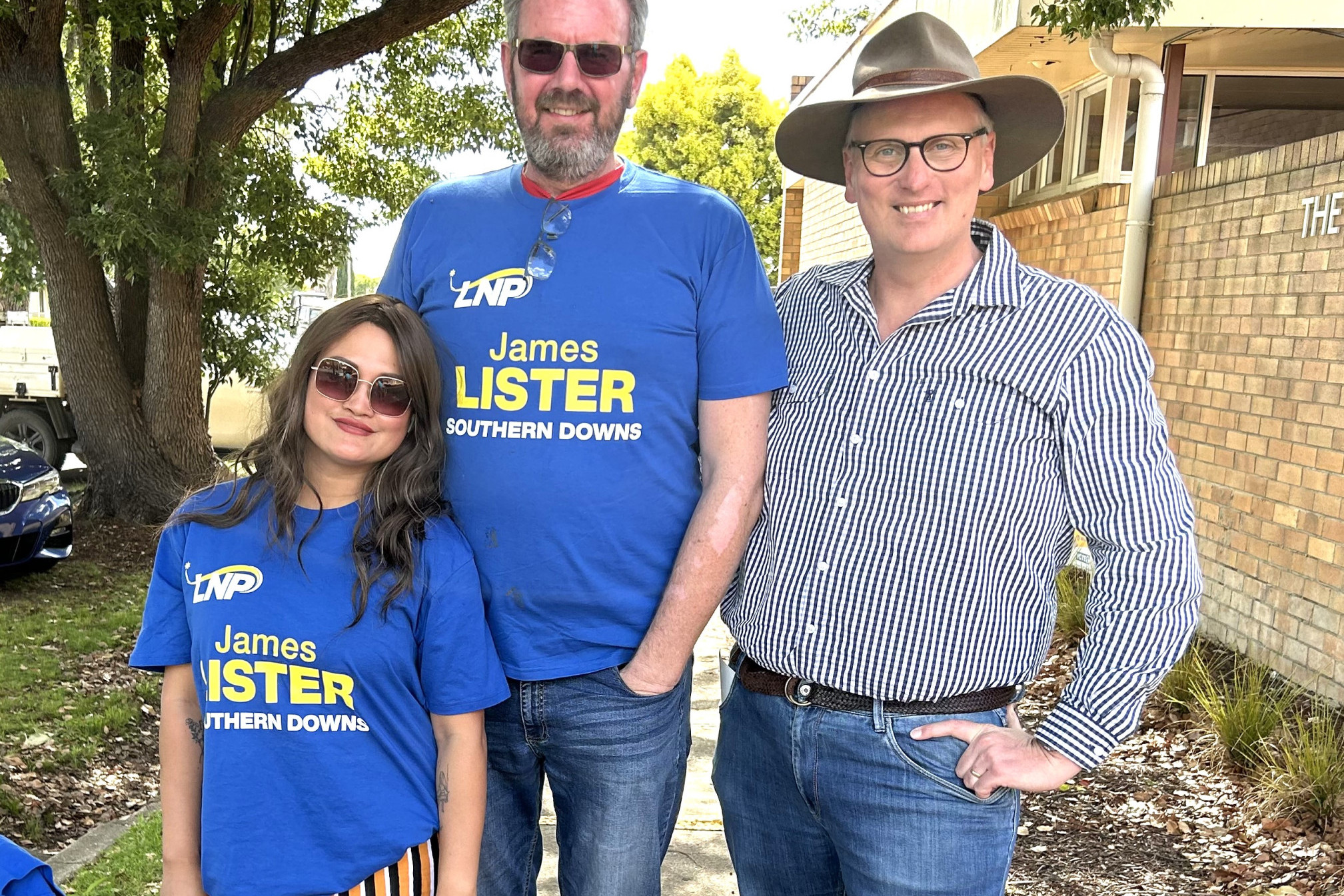 MP James Lister (right) in Allora on election day with his “mate” Hamish Troutbeck and supporter Aime.