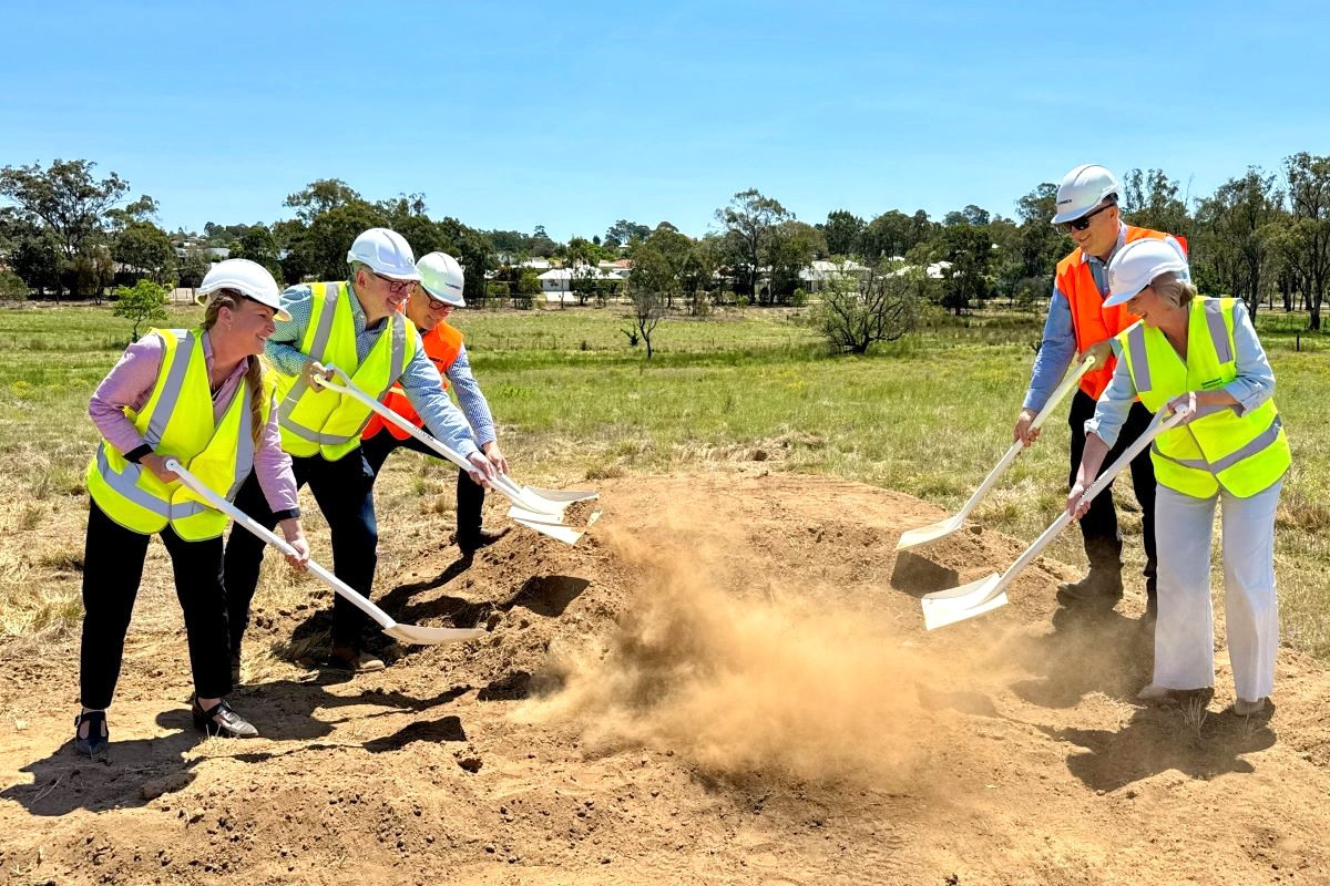Minister Young (front, right) helps begin the housing process in Warwick.