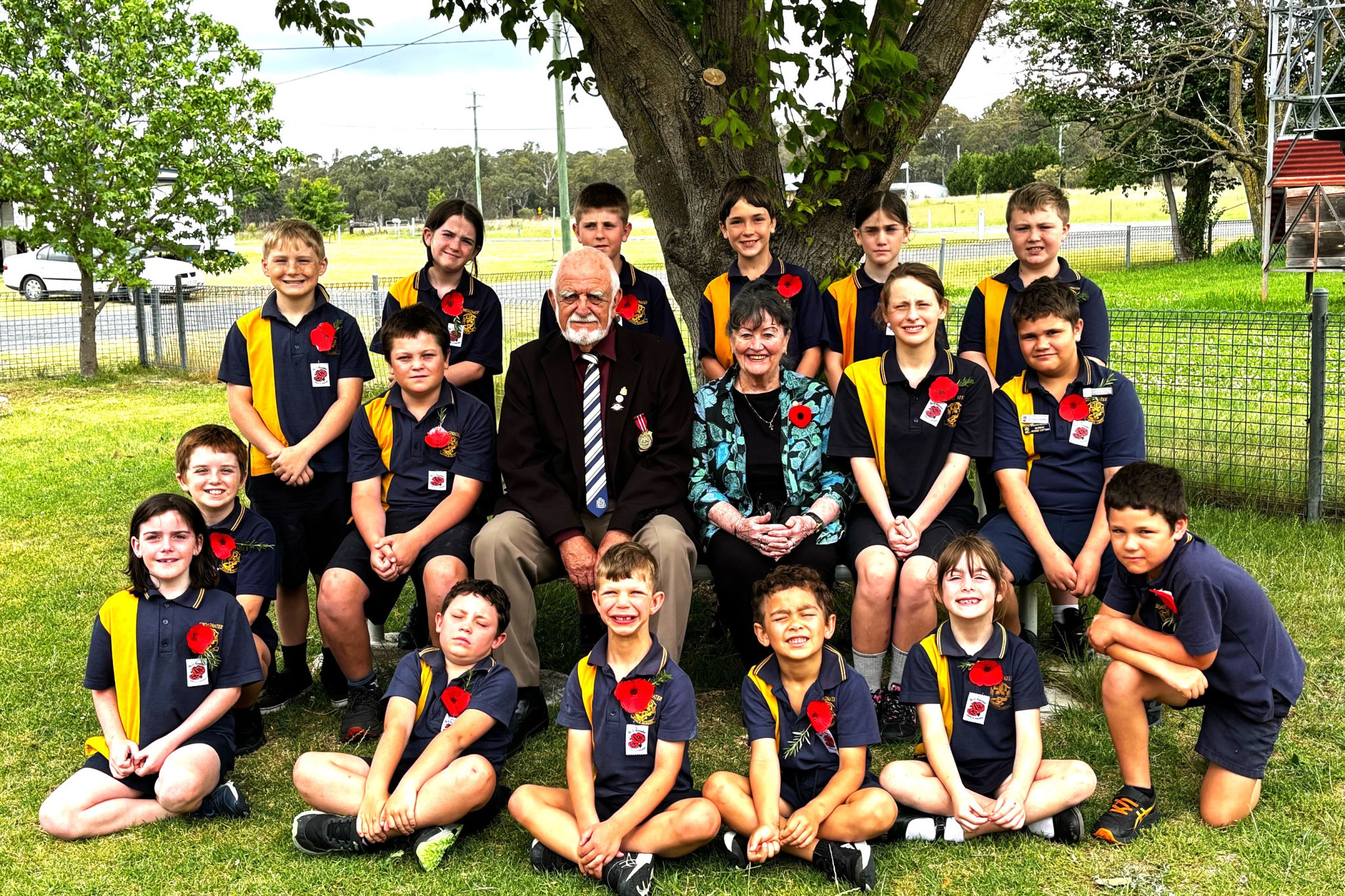 Ernie and Marlene Jones (pictured in middle) went to Broadwater State School on November 11, and marked the day of Remembrance, saying, "the students' sincerity was so apparent, obviously influenced by the dedication of the teachers and the guidance of their parents. Photo used with permission.