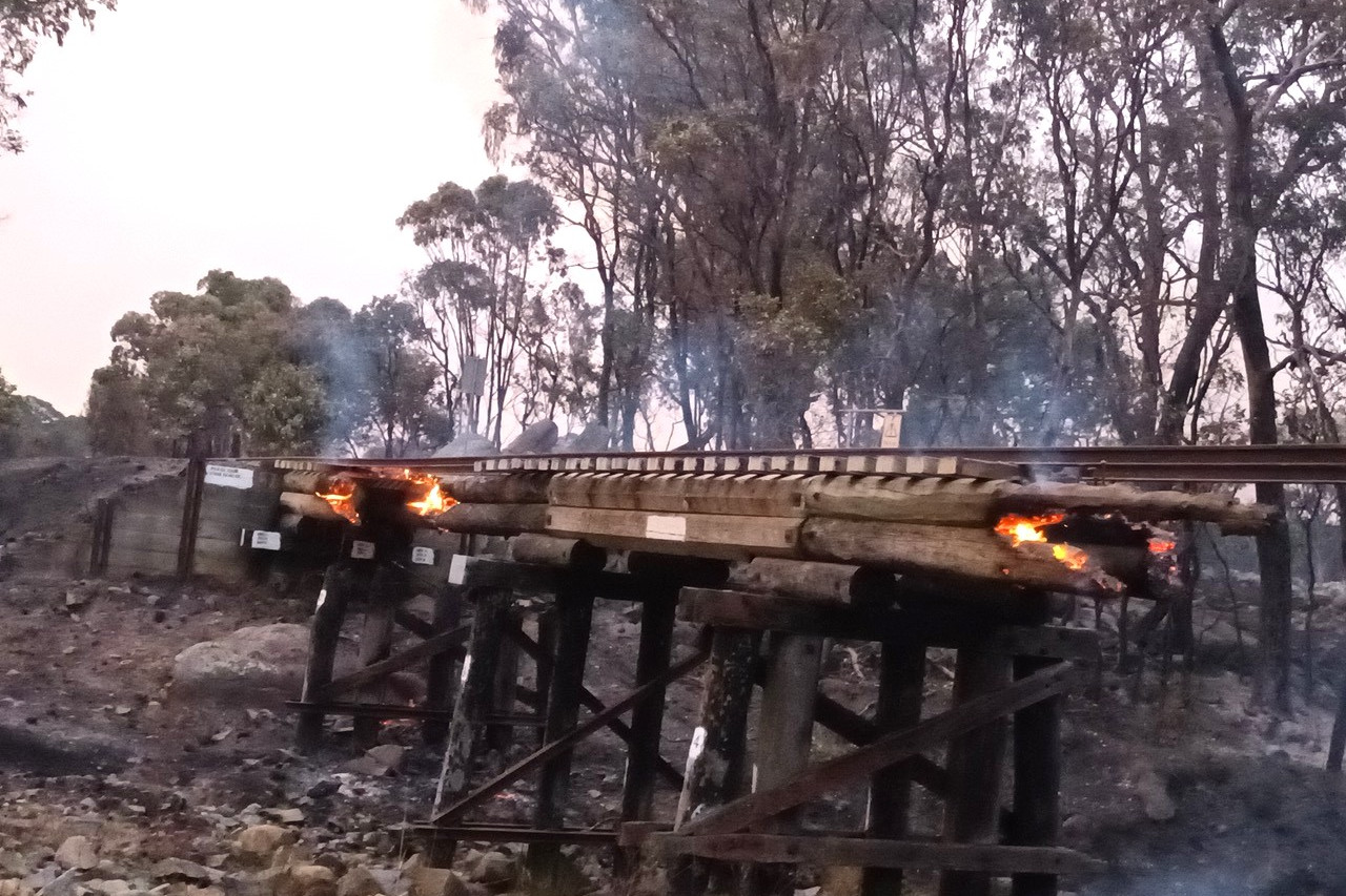 A burning bridge on the train line between Wallangarra and Stanthorpe during bushfires last November. Photo: Allen Crosthwaite.